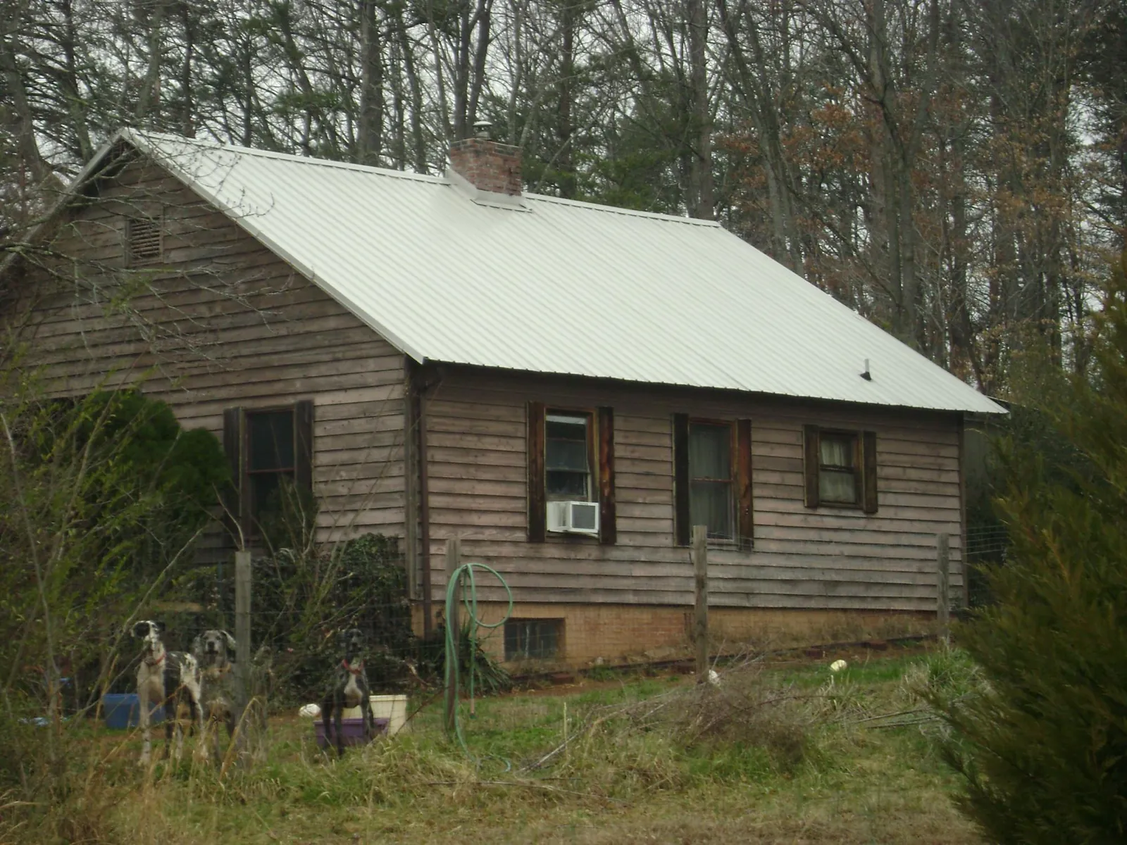 White metal roof on an old wood sided farmhouse, from a Metal Roof Installation job in Coulee City